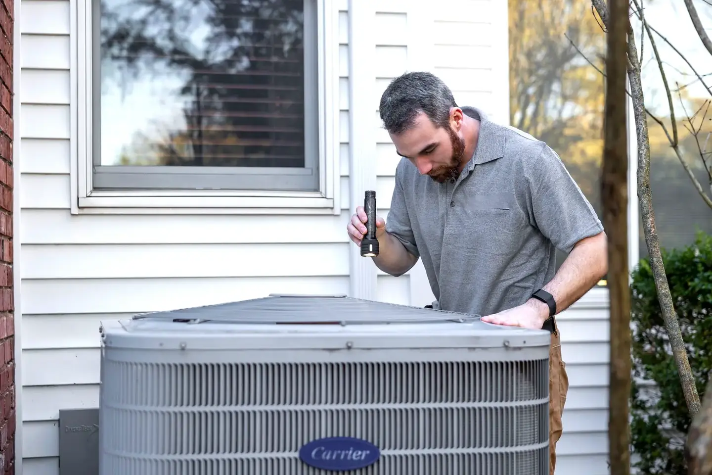 Wilson Family technician servicing a home air conditioning unit in Rockwall, TX